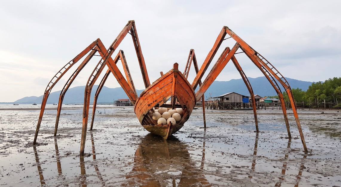 A former fishing boat re-authored as a sculptural work on the Kep mudflat